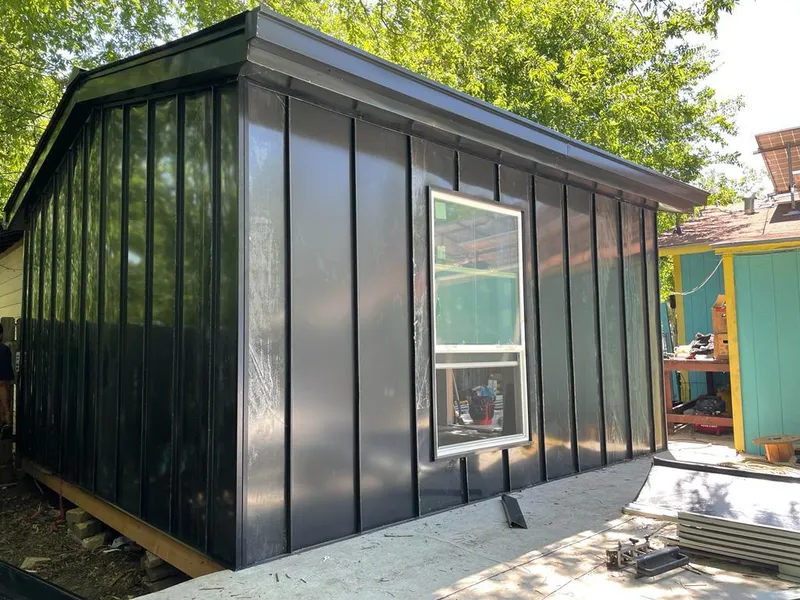 Black standing seam metal wall panels for Roof Inspection in Parsons