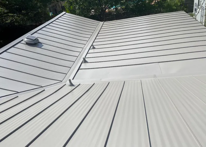 Solar attic fan installed on a metal roof for Roof Ventilation in Parsons
